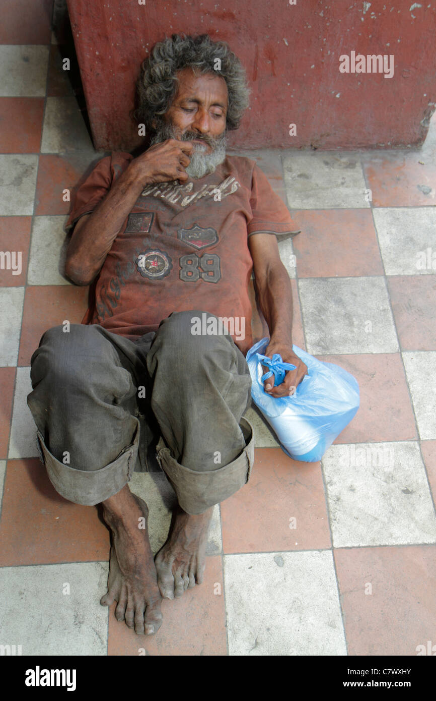 Granada Nicaragua,Central America,Calle Real Xalteva,vagrant,homeless,derelict,poverty,man men male adult adults,dirty,barefoot,grimy,lying on dirty f Stock Photo