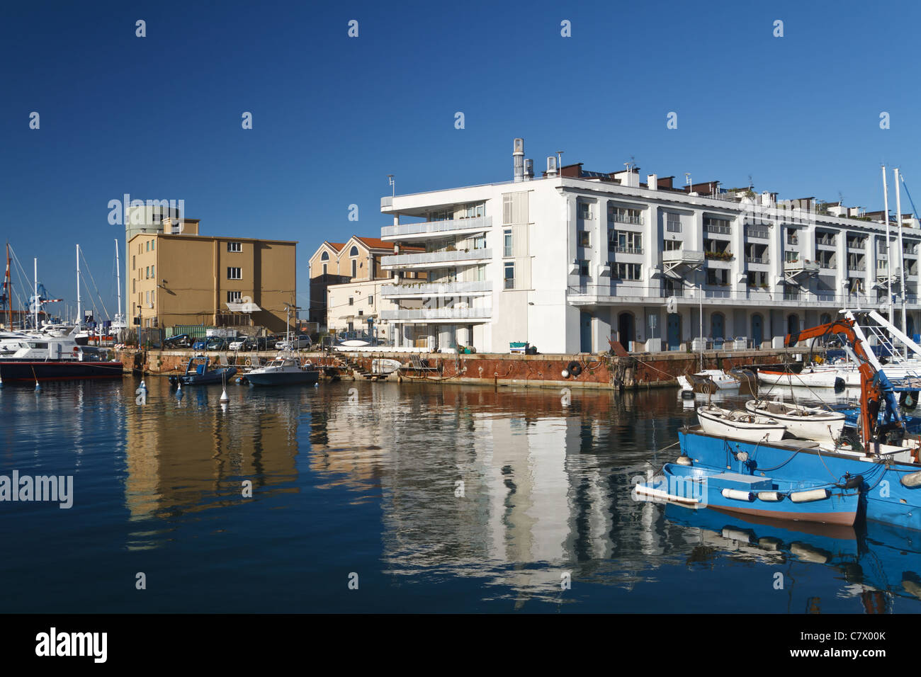 warehouse, fishing boat and sail boat in Genoa port, Italy Stock Photo