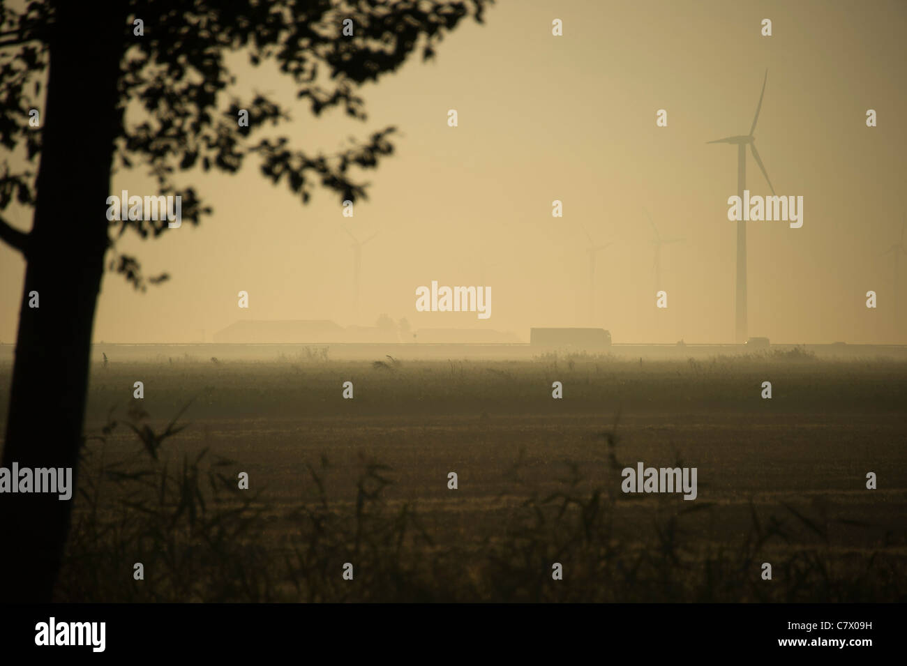 Silhouette of wind turbine in early morning Stock Photo
