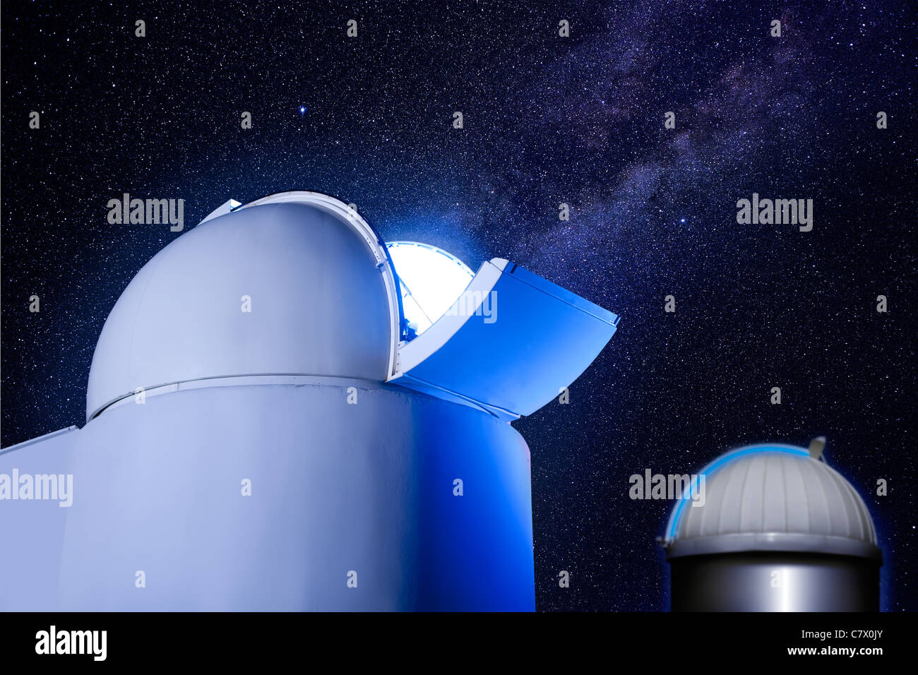 astronomical observatory dome in night with stars and glowing light Stock Photo