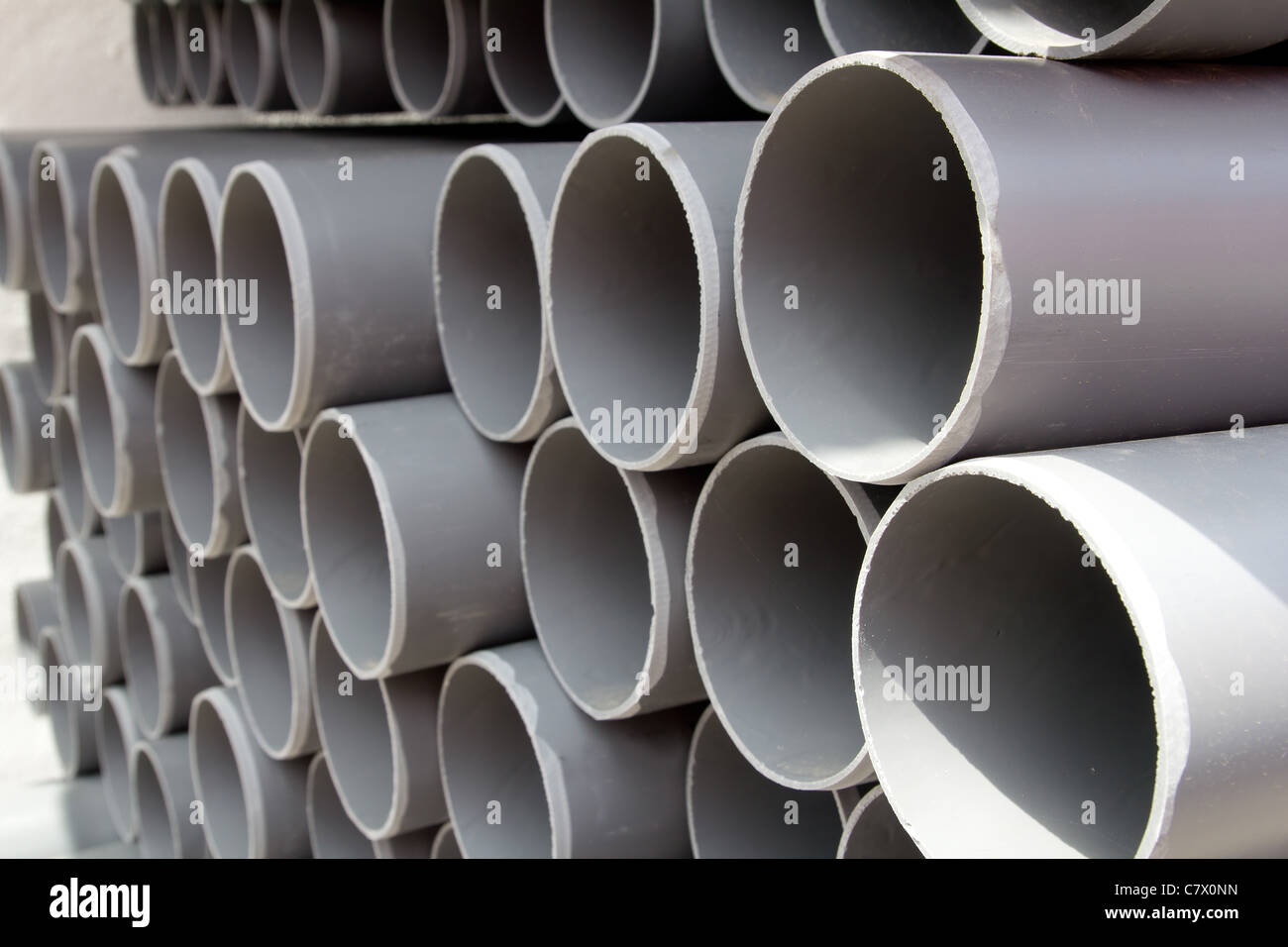 gray PVC tubes plastic pipes stacked in rows pattern Stock Photo Alamy