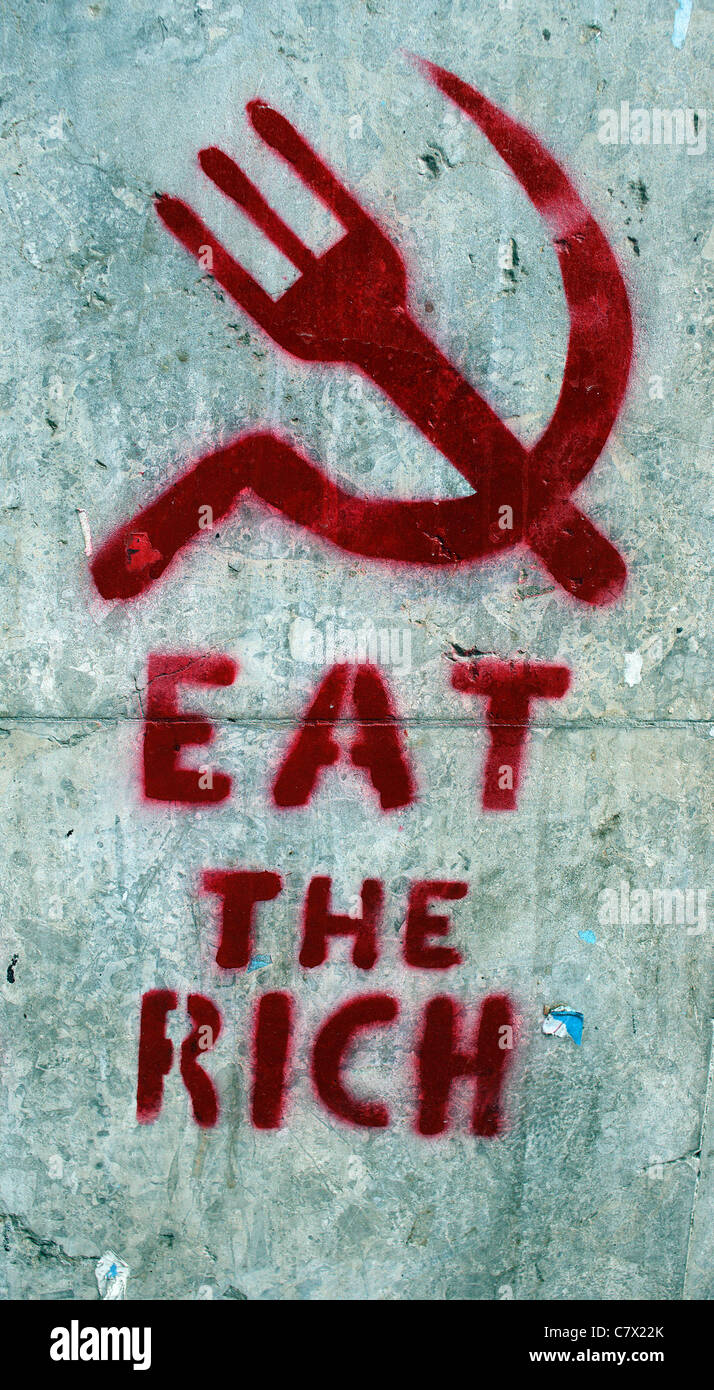 Eat the rich inscription on the wall Naples Italy Stock Photo