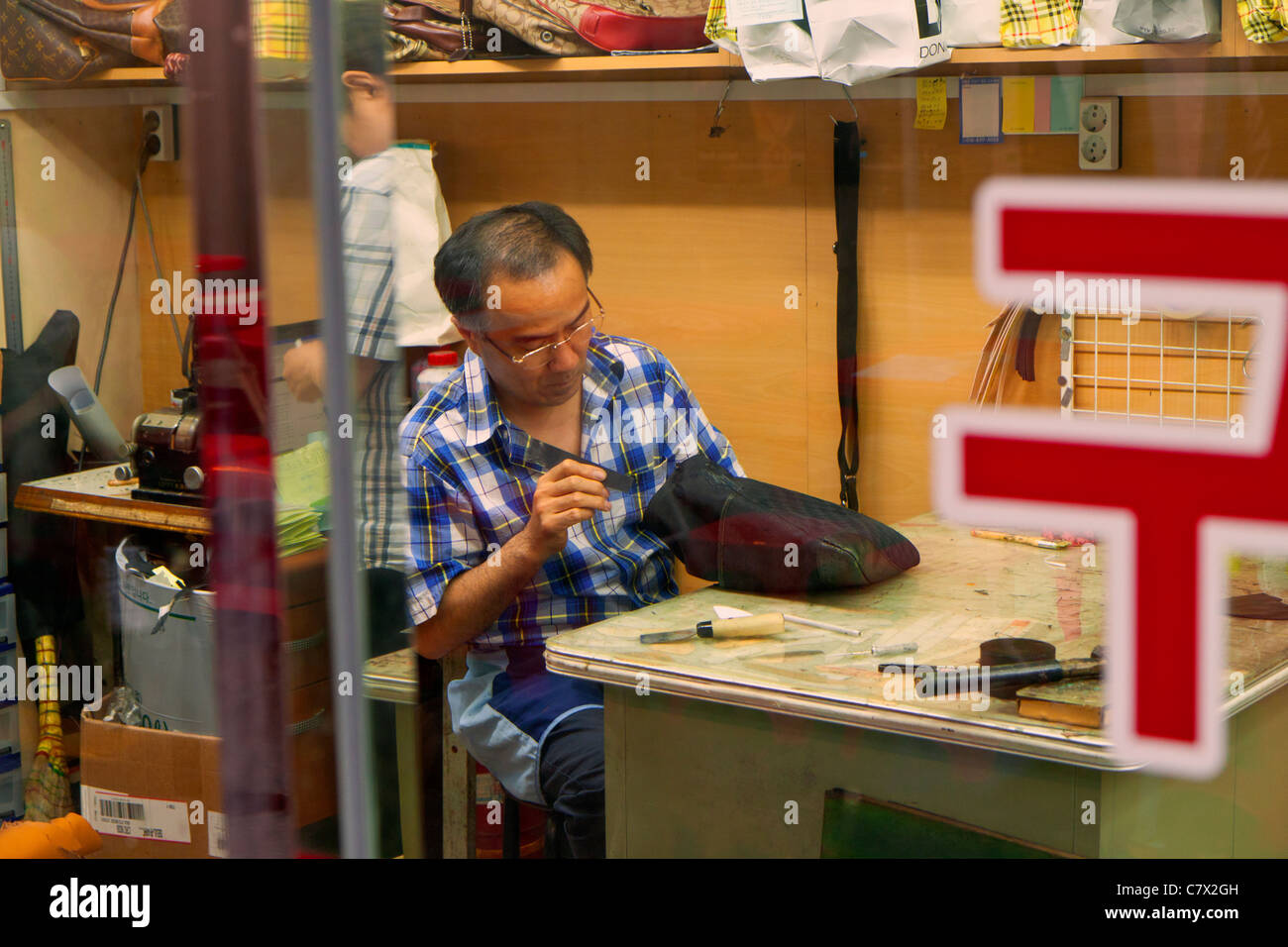 Skilled worker applies his trade in downtown Seoul Stock Photo