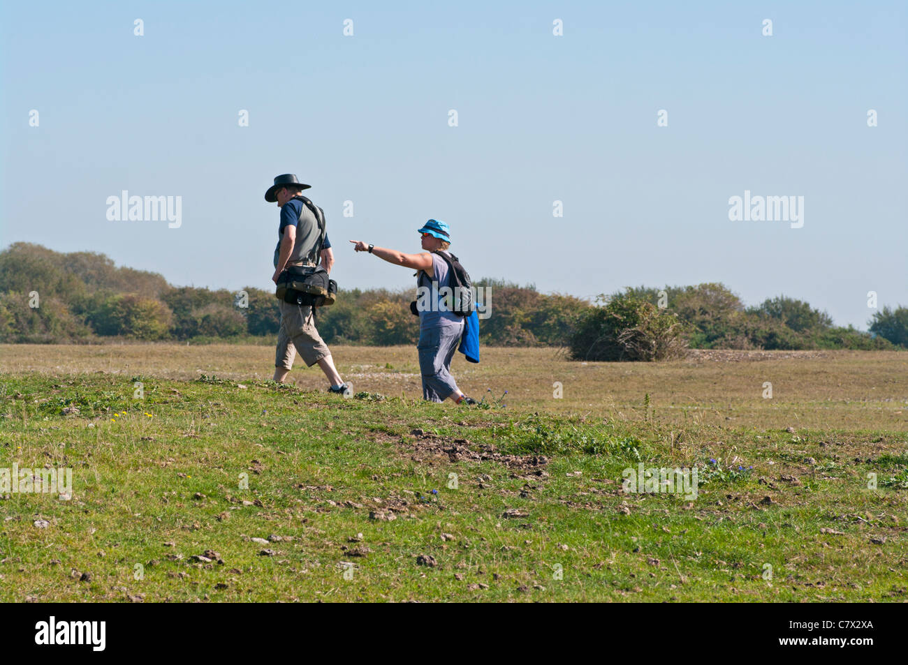 Male And Female walkers ramblers Walking Through The English Countryside UK Stock Photo