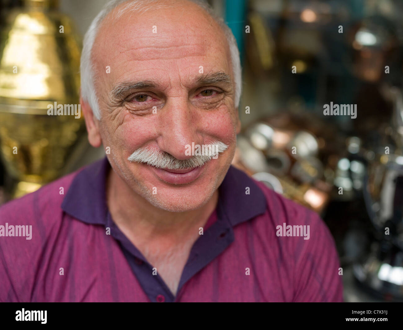 Turkish man in front of his market stall selling copperware in Istanbul Turkey Stock Photo