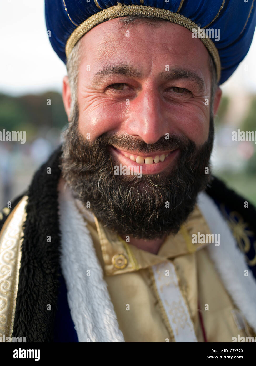 Happy Turkish man dressed as a sultan stands before the Blue Mosque in Istanbul Turkey Stock Photo
