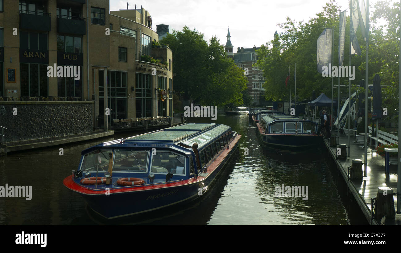 Boats on canal beside hard rock cafe Amsterdam, The Netherlands Stock Photo