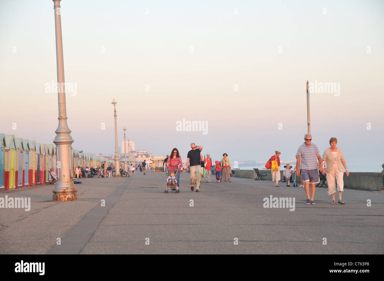 People walking on the Hove seafront at dusk, Hove, UK Stock Photo - Alamy