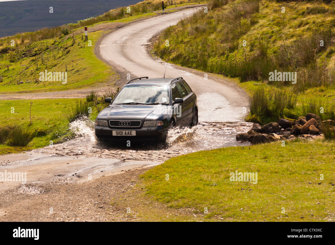 A ford crosses the road between Arkengarthdale and swaledale in North Yorkshire , England , Britain , Uk Stock Photo