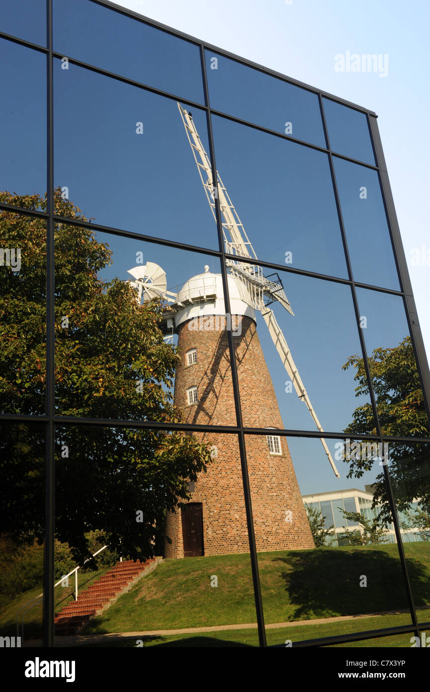 Reflection of Chiseldon windmill in office windows at Windmill Hill Business Park Swindon Wiltshire England UK Stock Photo