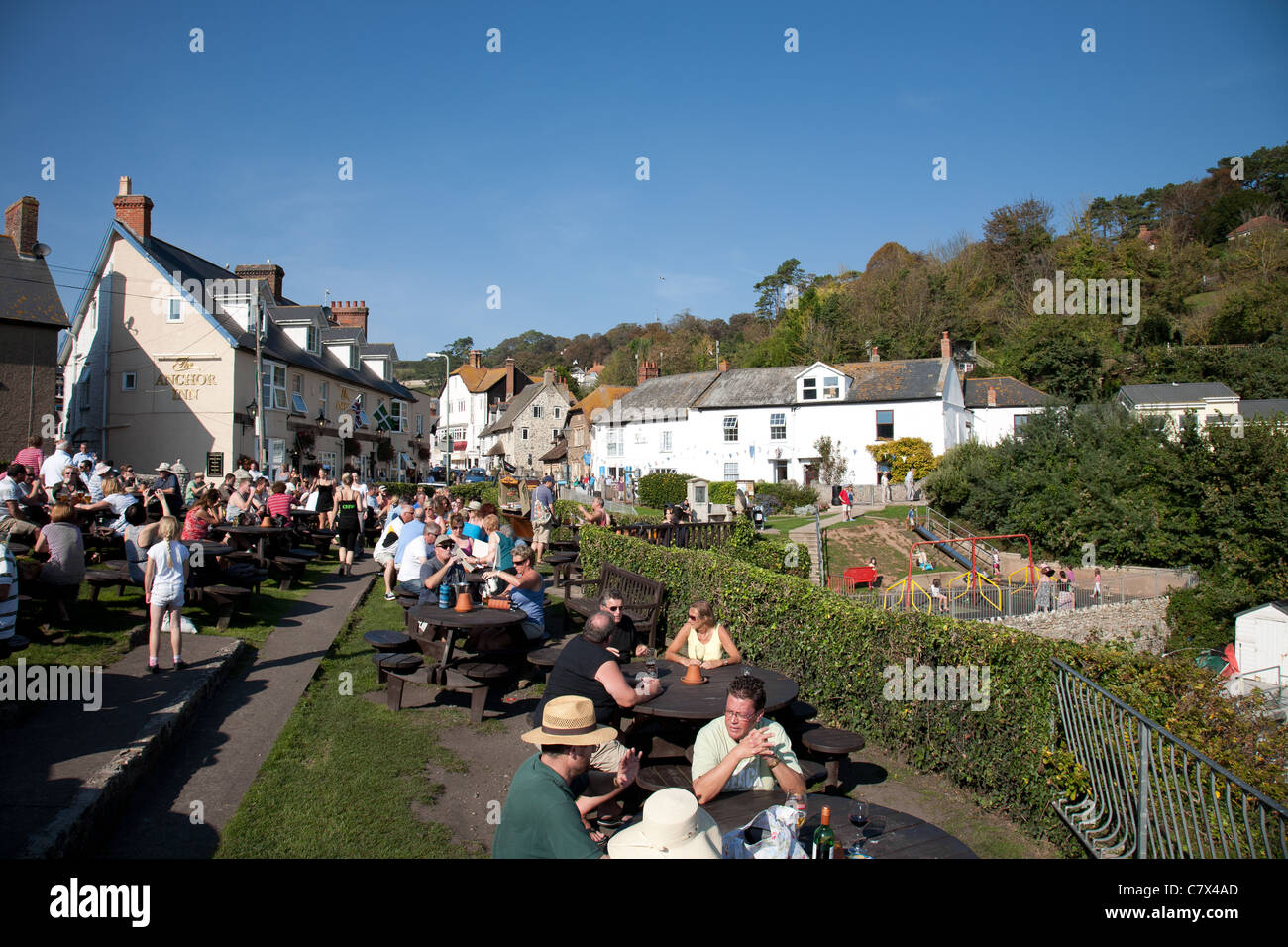 People eating in a pub garden in the village of Beer in Devon Stock