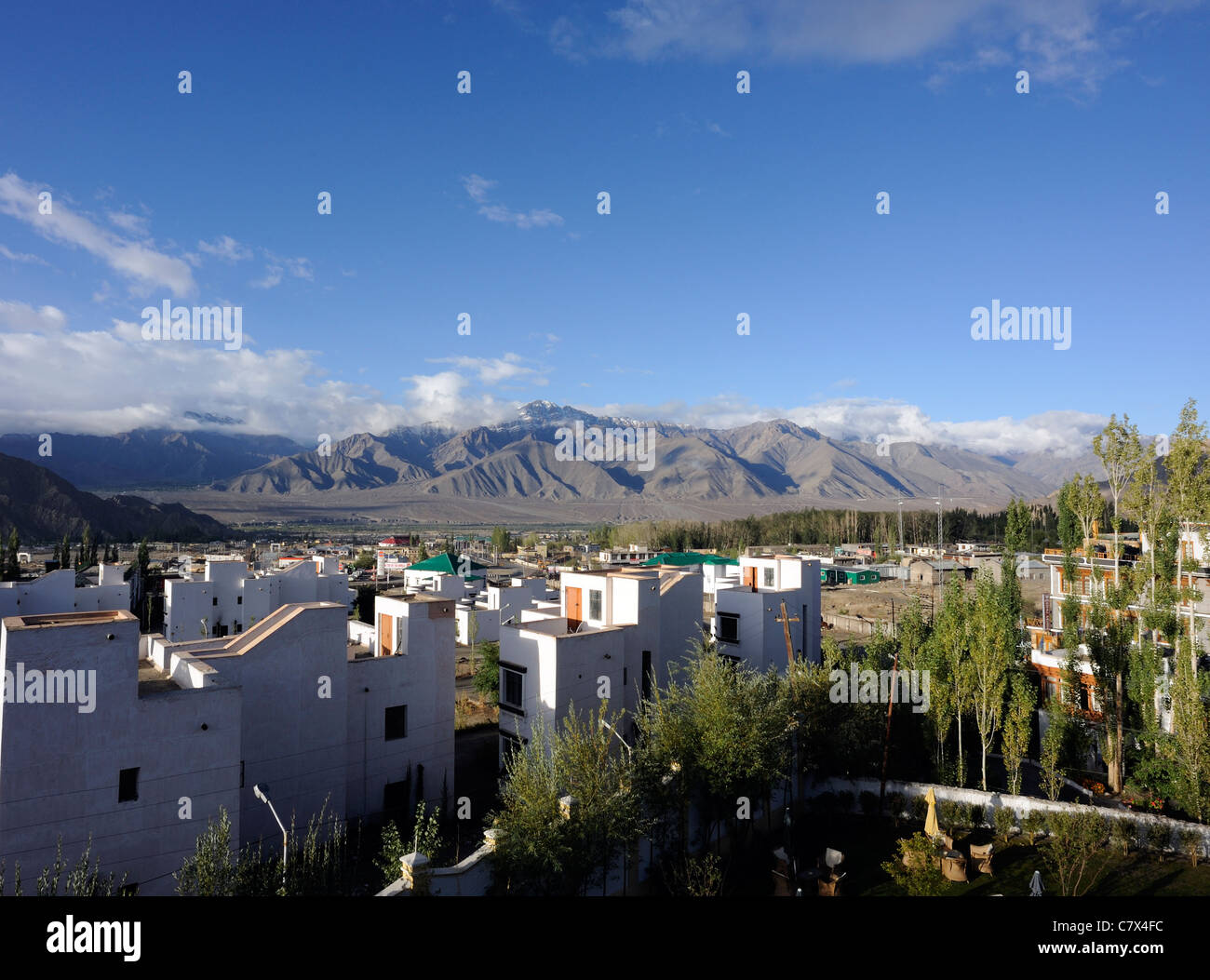 New buildings on the edge of Leh with the Zanskar  mountains in the background. Leh, Ladakh, Republic on India. Stock Photo