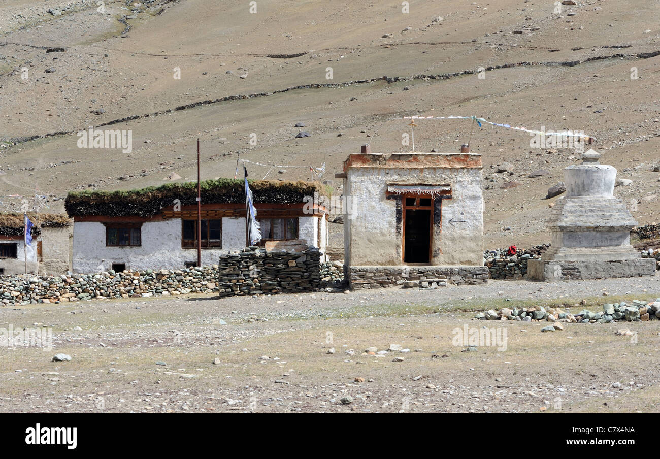 A traditional flat-roofed house in the village of Rangdum in Zanskar . Wood for fuel and hay are stored on the roof . Stock Photo