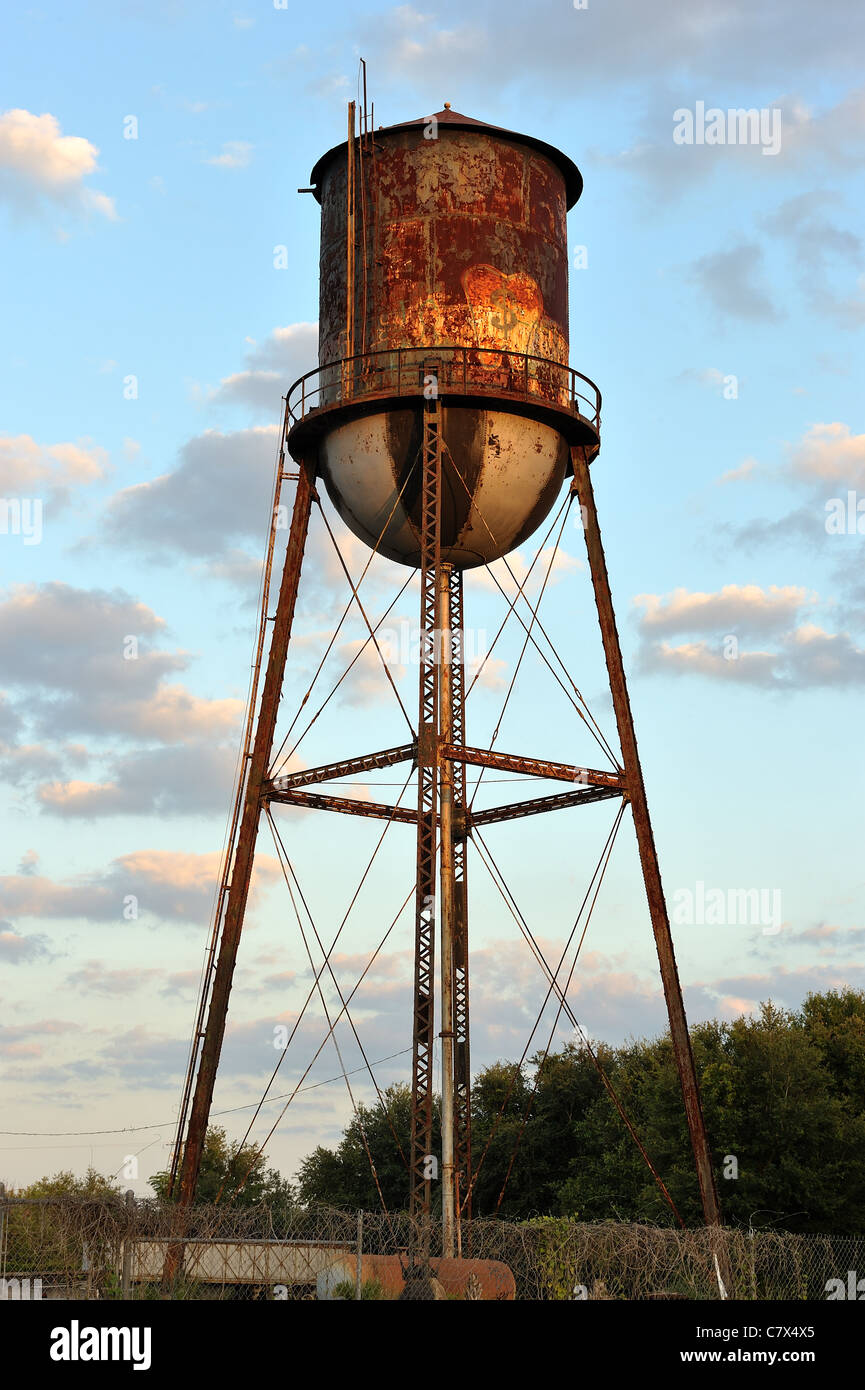 An old rusting industrial or city  water tower in a suburb of Tampa Florida, USA. Stock Photo