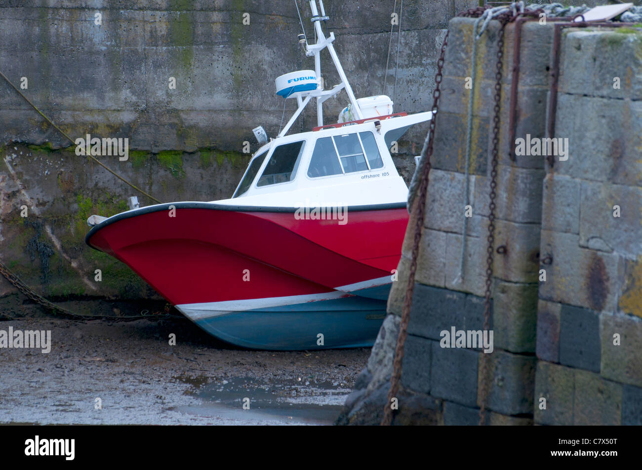 Dive Boat in St. Abbs Harbour, Scotland at low tide Stock Photo