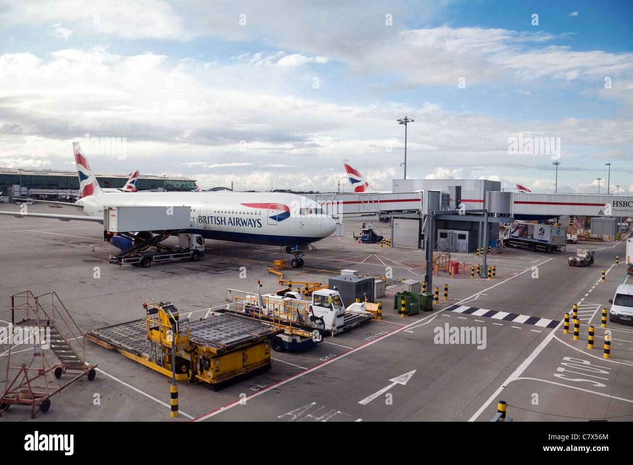 British airways plane loading luggage on the tarmac, Terminal 5, Heathrow airport London UK Stock Photo