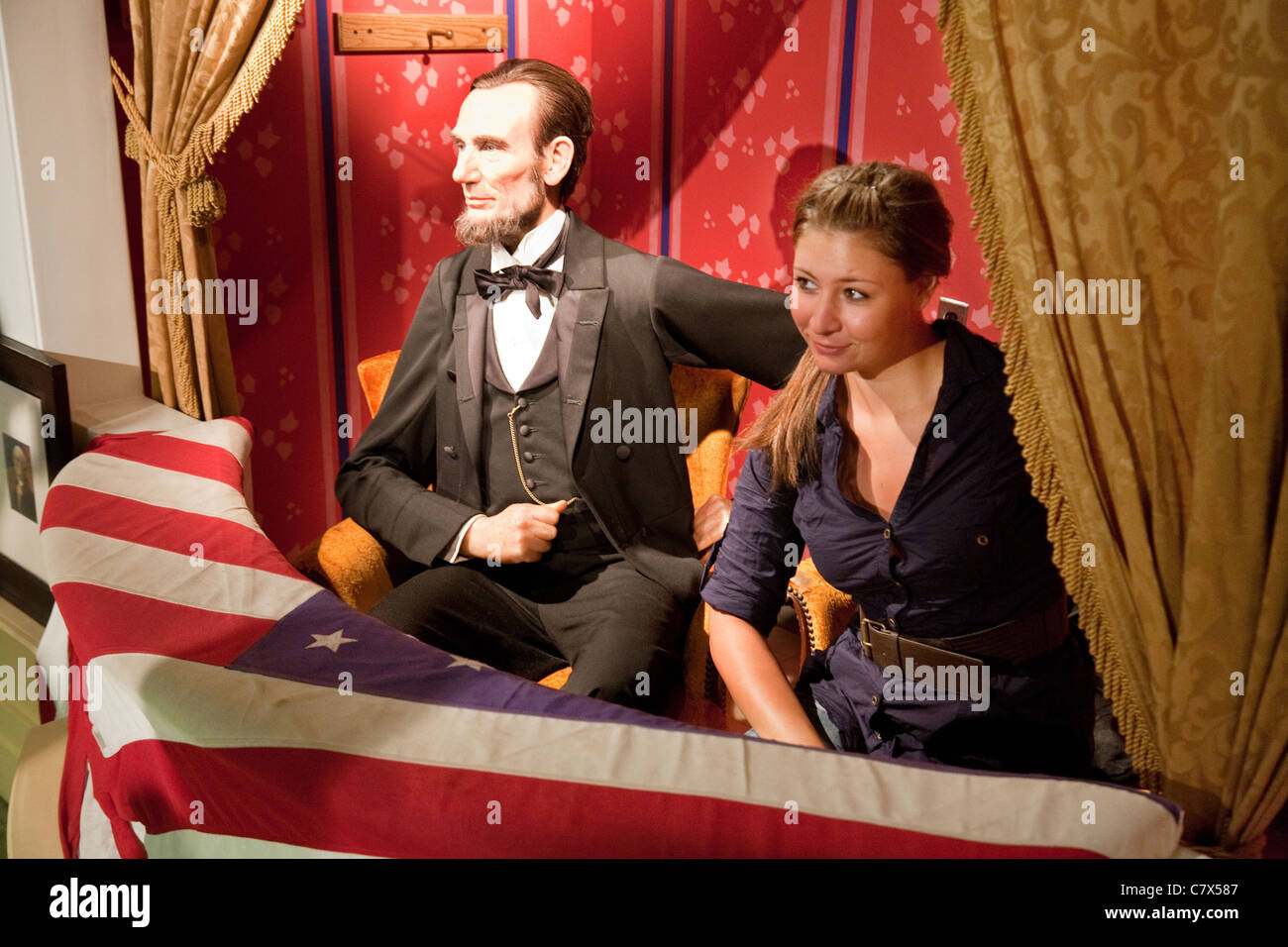 A Tourist posing with President Abraham Lincoln at Madame Tussauds waxworks, Washington DC USA Stock Photo