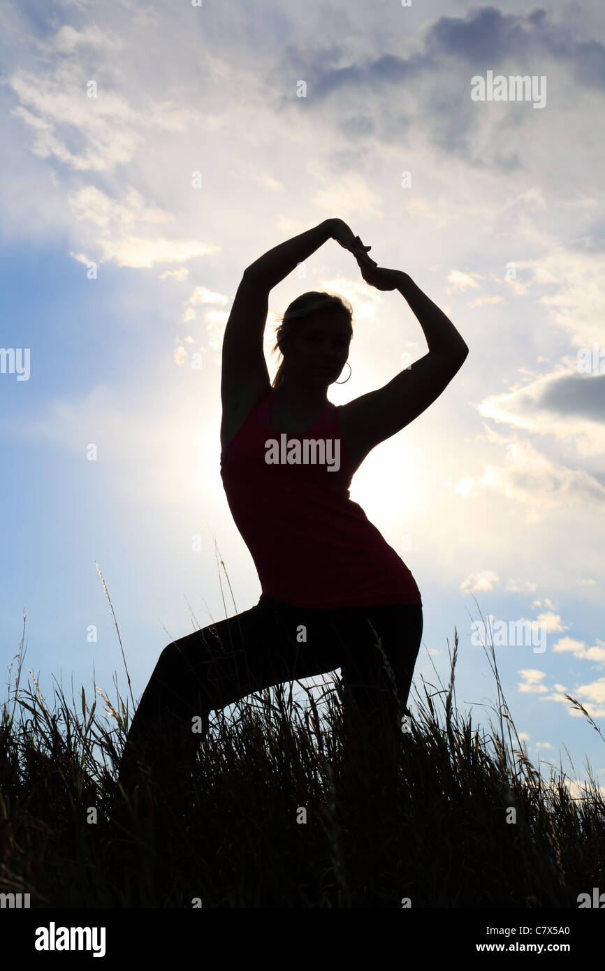 The silhouette of a gymnast stretching in a field Stock Photo - Alamy