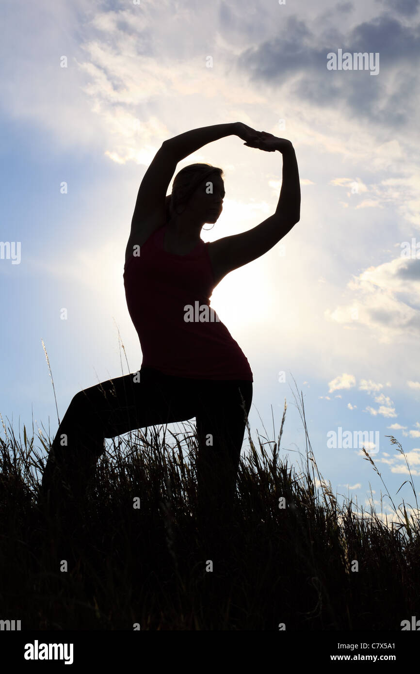 The silhouette of a gymnast stretching in a field Stock Photo - Alamy