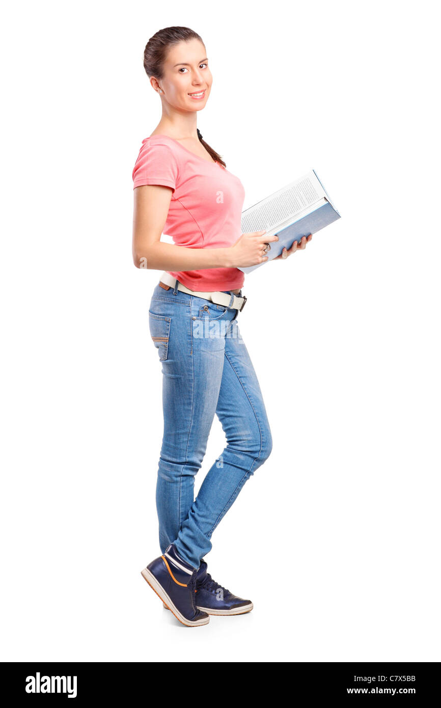 Full length portrait of a school girl holding a book Stock Photo - Alamy