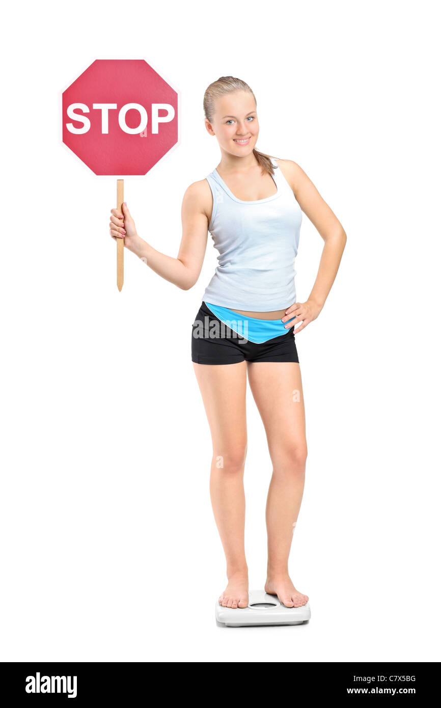 Full length portrait of a weight loss girl standing on a weight scale