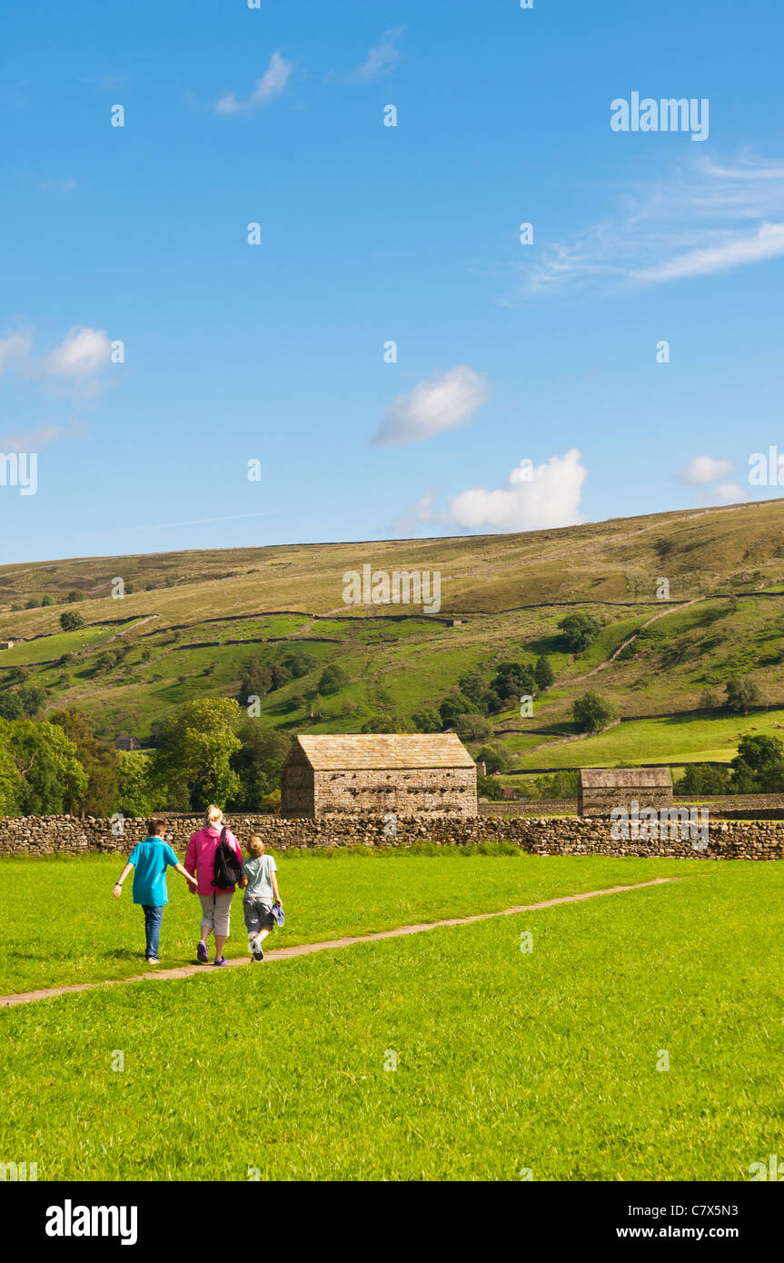 A family walking at Muker in Swaledale in North Yorkshire , England , Britain , Uk Stock Photo