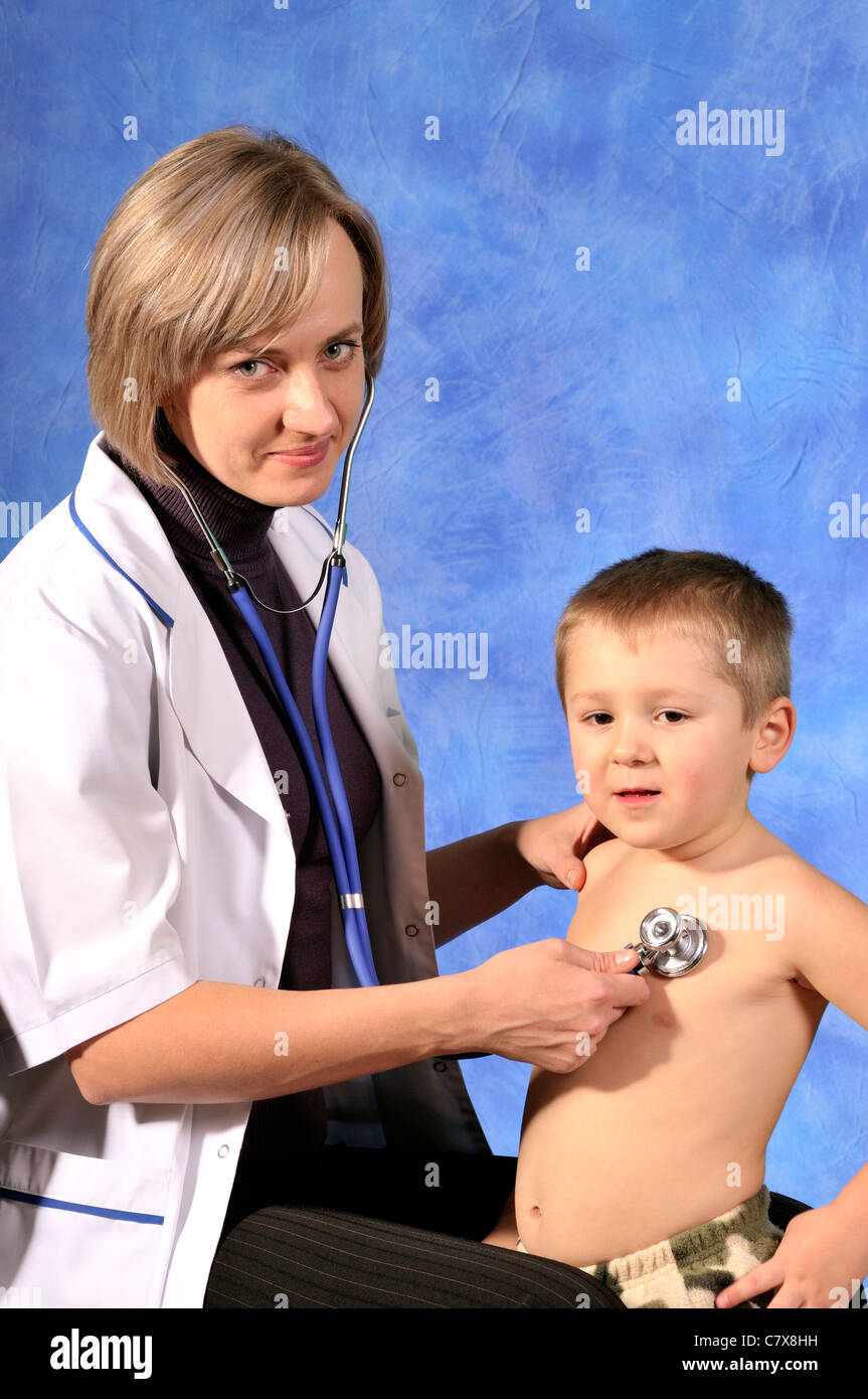 pediatrist examines little boy Stock Photo