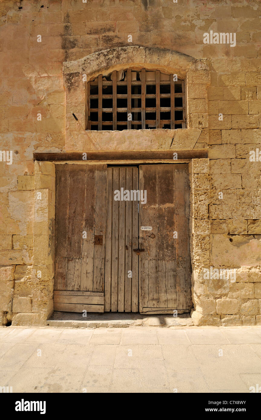Grunge No Admittance sign on old wooden door locked with padlock in Mdina, Malta Stock Photo