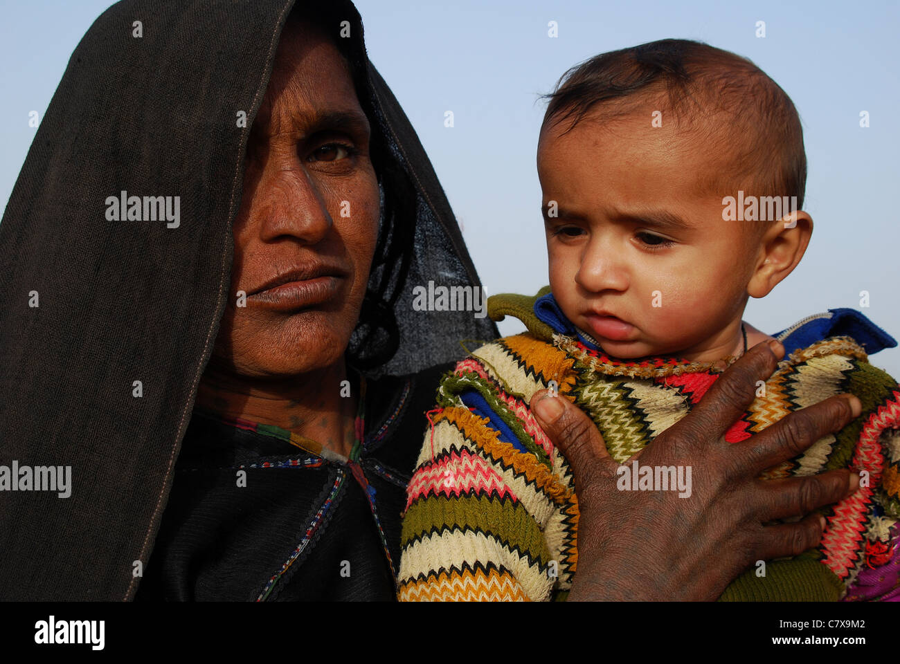 A woman is holding proudly her child, a boy ( India) Stock Photo