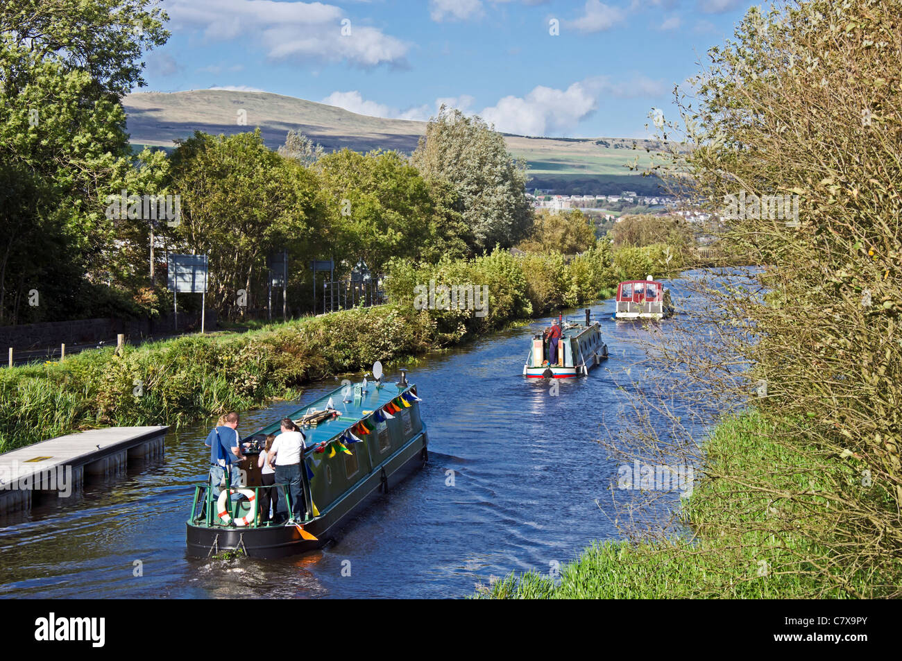 Canal boats sail through the Forth & Clyde Canal at Twechar in Scotland on 10 years celebration of canal re-opening Stock Photo