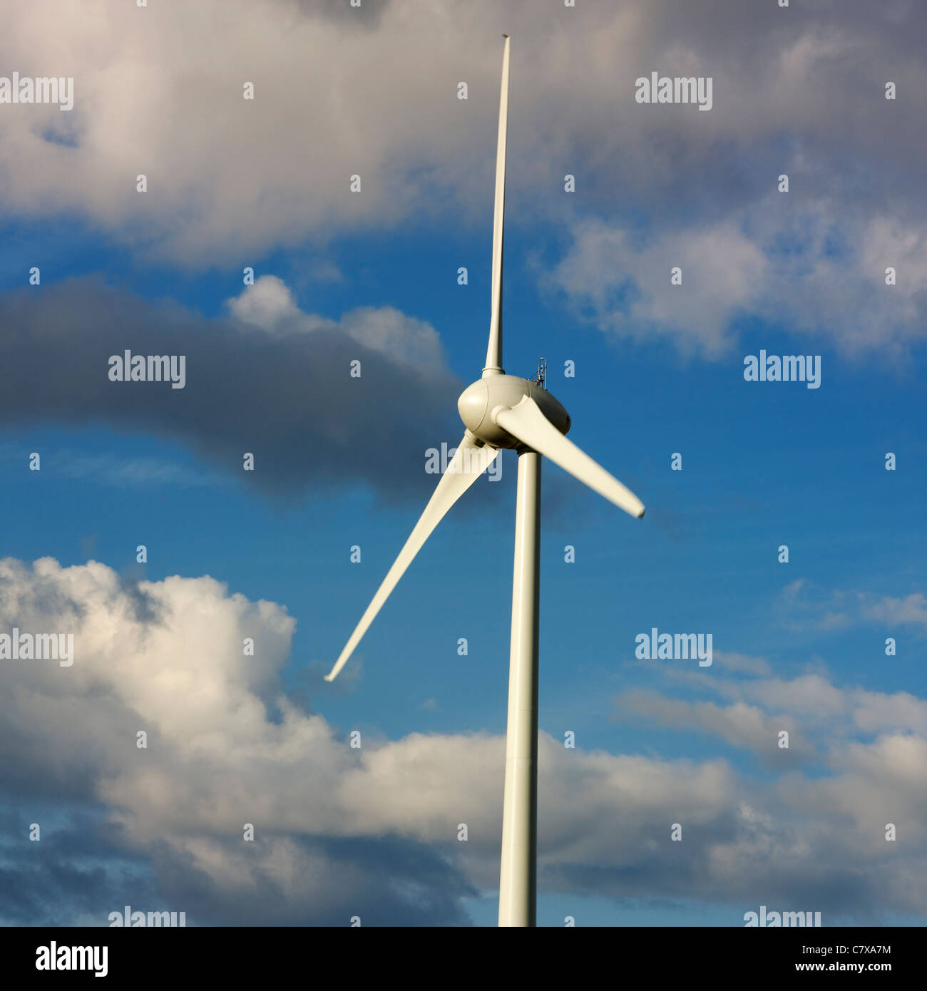 Wind turbine under cloudy sky Stock Photo - Alamy