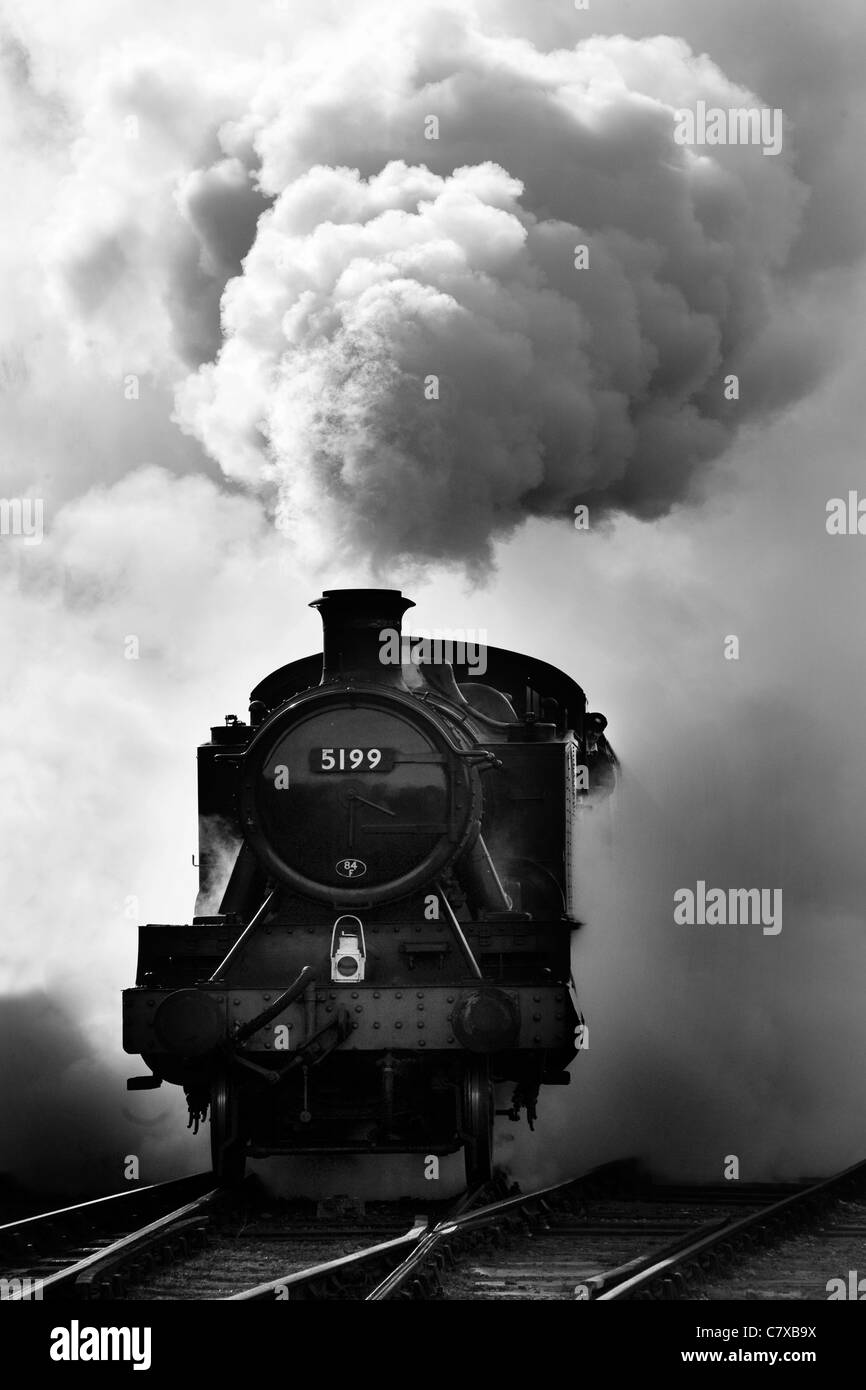 A black and white image of a steam train at the bluebell railway Sussex Stock Photo