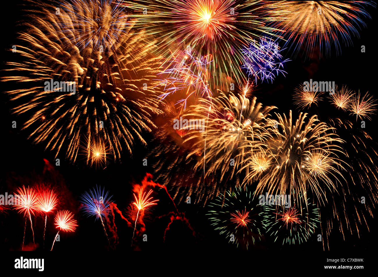 Fireworks of multiple colors bursting against a black background Stock Photo