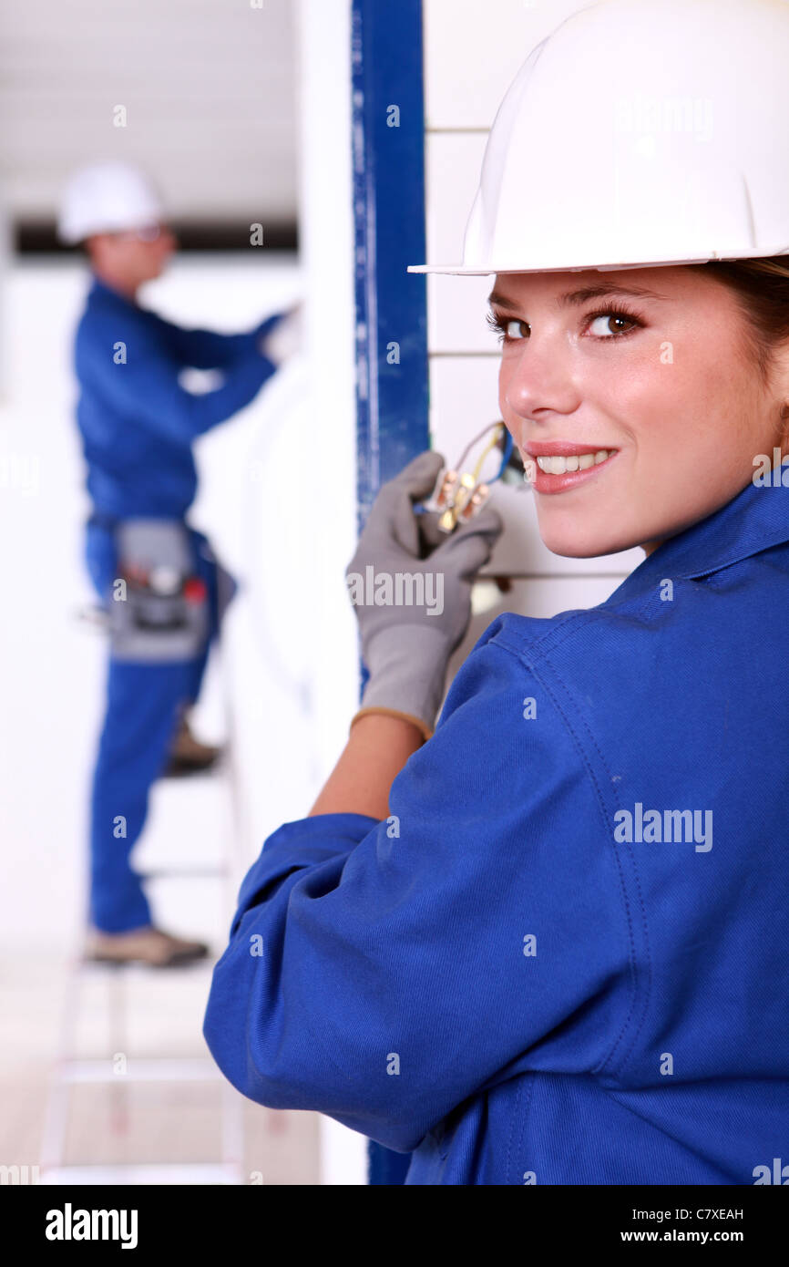 Female electrician installing a power point Stock Photo Alamy