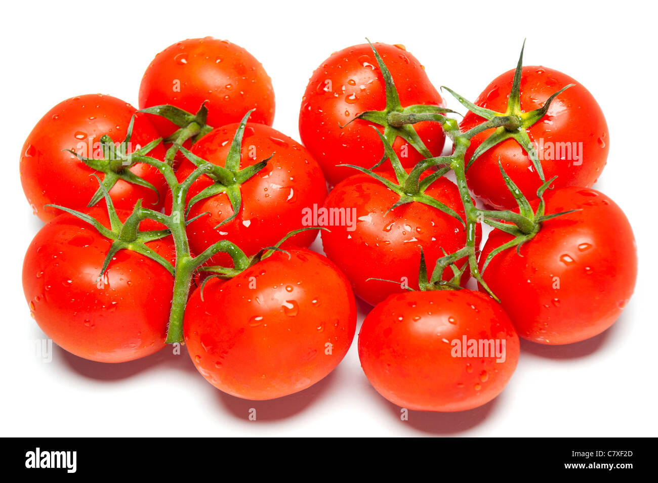 Ripe red tomatoes on isolated white studio background Stock Photo