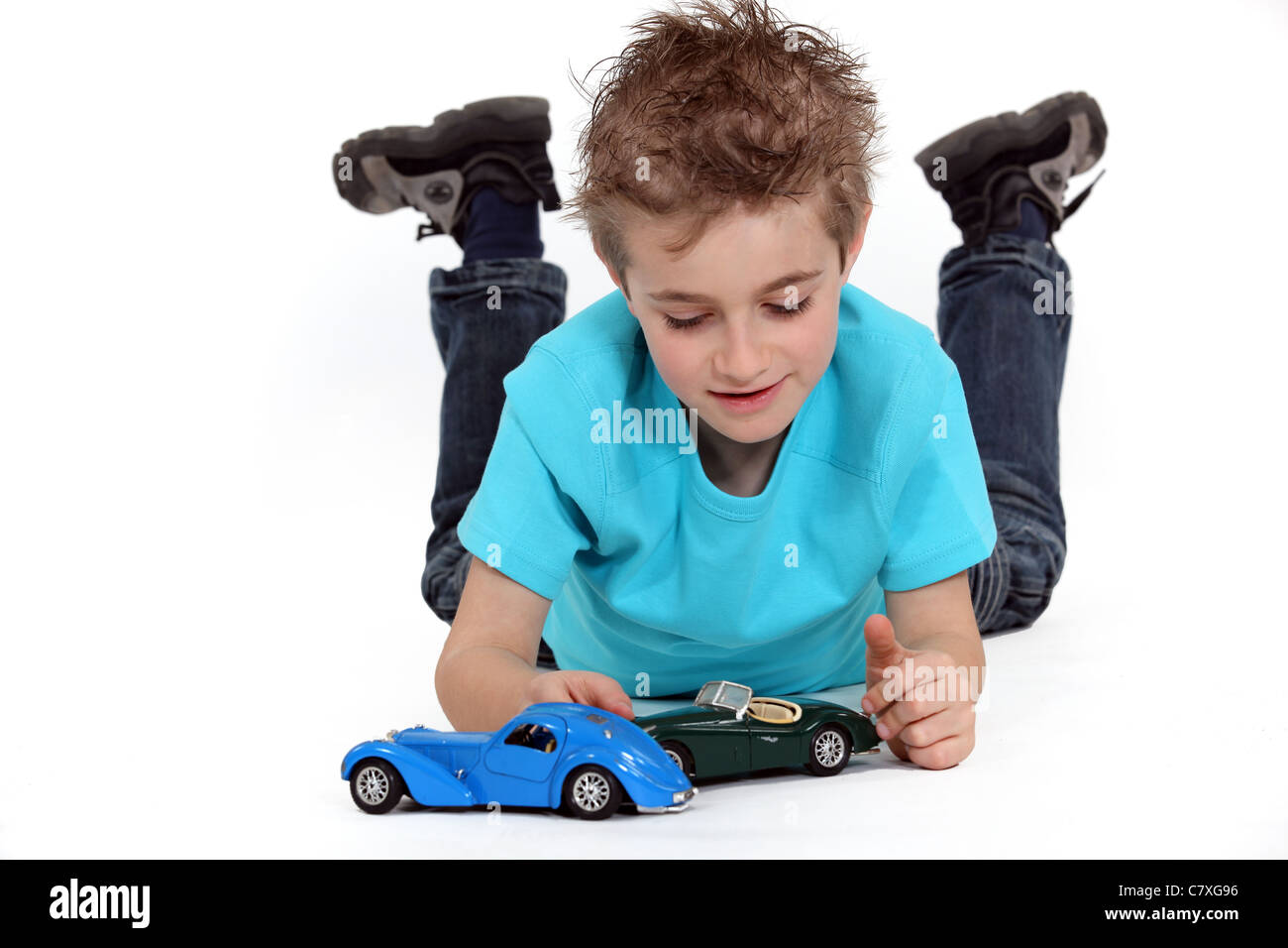 Little boy playing with toy cars Stock Photo - Alamy