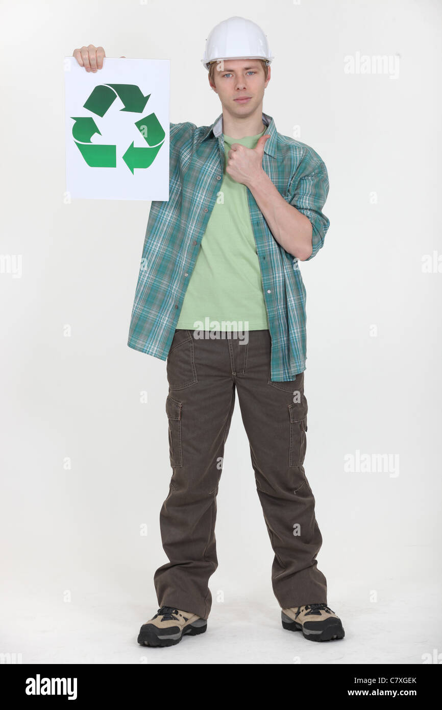 Man holding sign with recycling symbol Stock Photo - Alamy