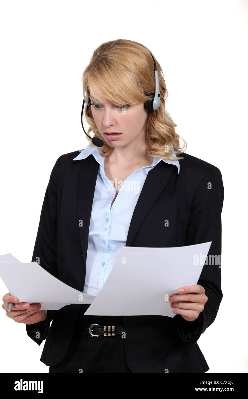 Surprised receptionist looking at some paperwork Stock Photo - Alamy