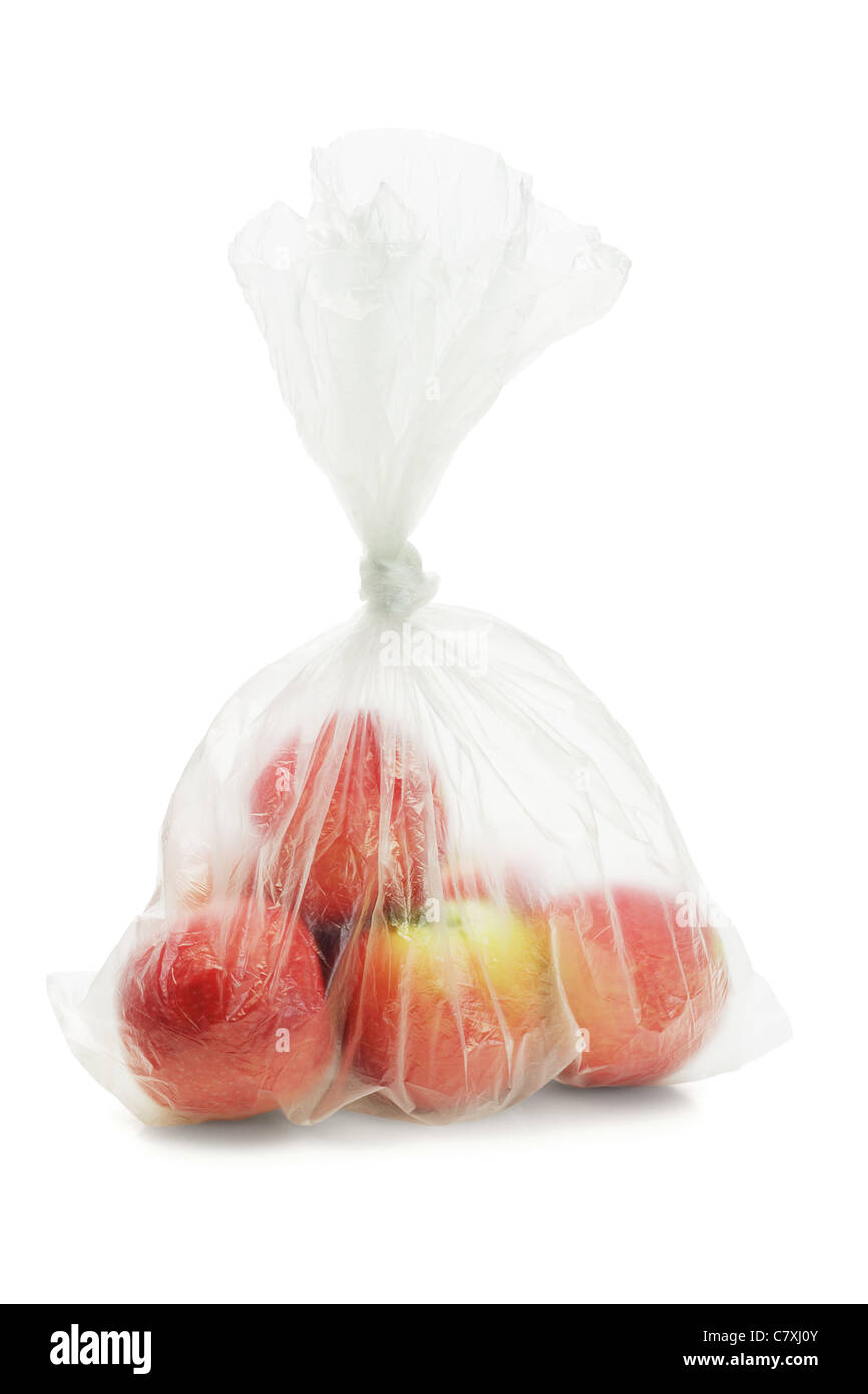 Red apples in translucent plastic bag on white background Stock Photo