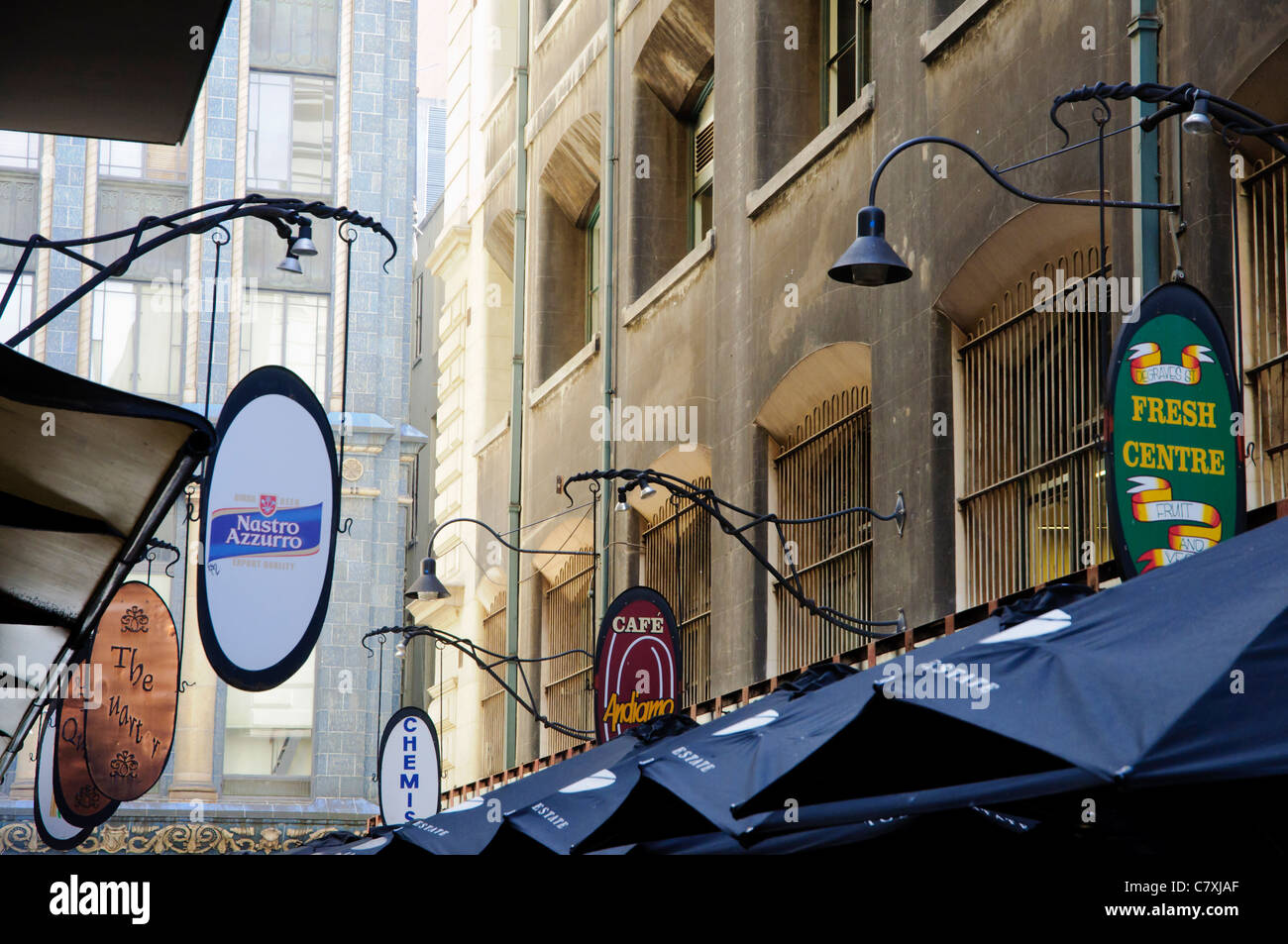 Signs for coffee shops above one of the laneways for which Melbourne, Australia, is known. Stock Photo