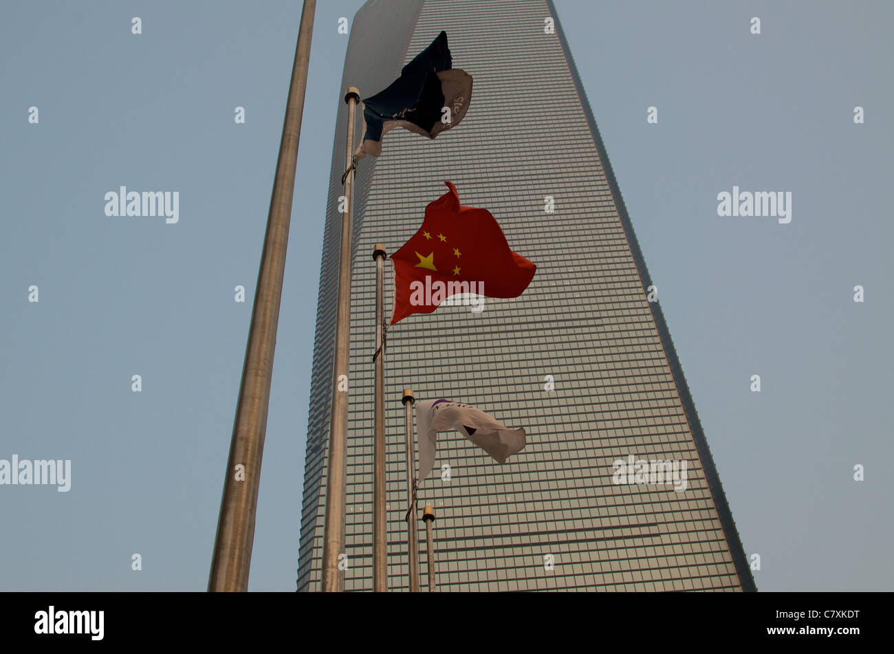 A Chinese flag flutters in front of the Shanghai World Financial Centre (SWFC). Stock Photo