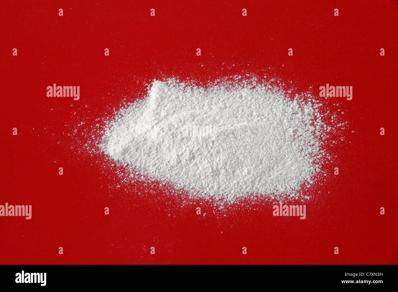 Sieved white flour on a red background Stock Photo