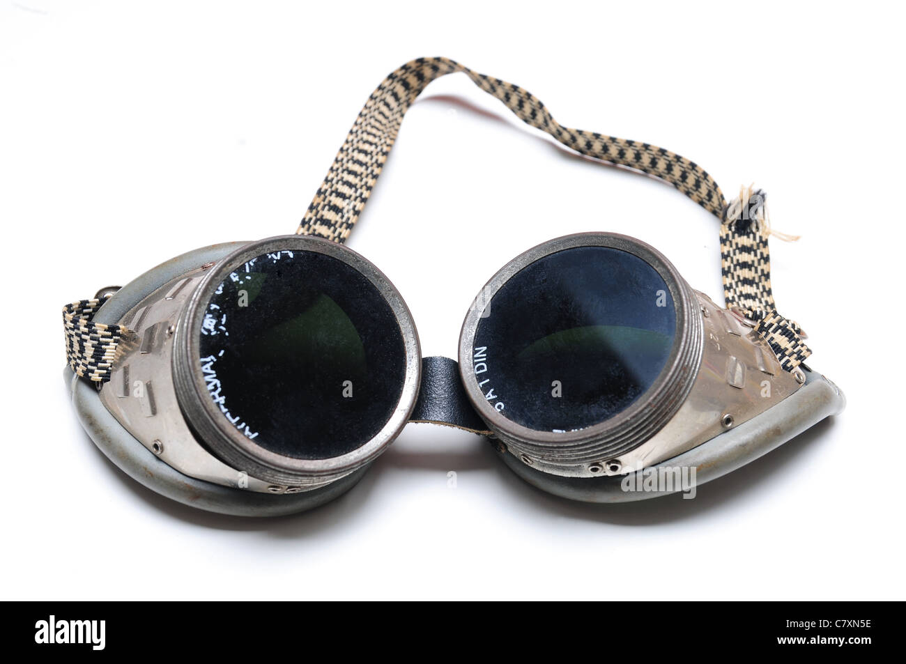 Used welding goggles with fingerprints over white background Stock Photo
