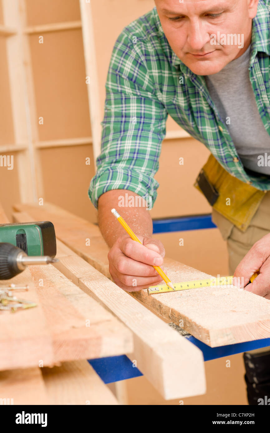 Handyman home improvement close-up of measure wooden board with ruler Stock Photo