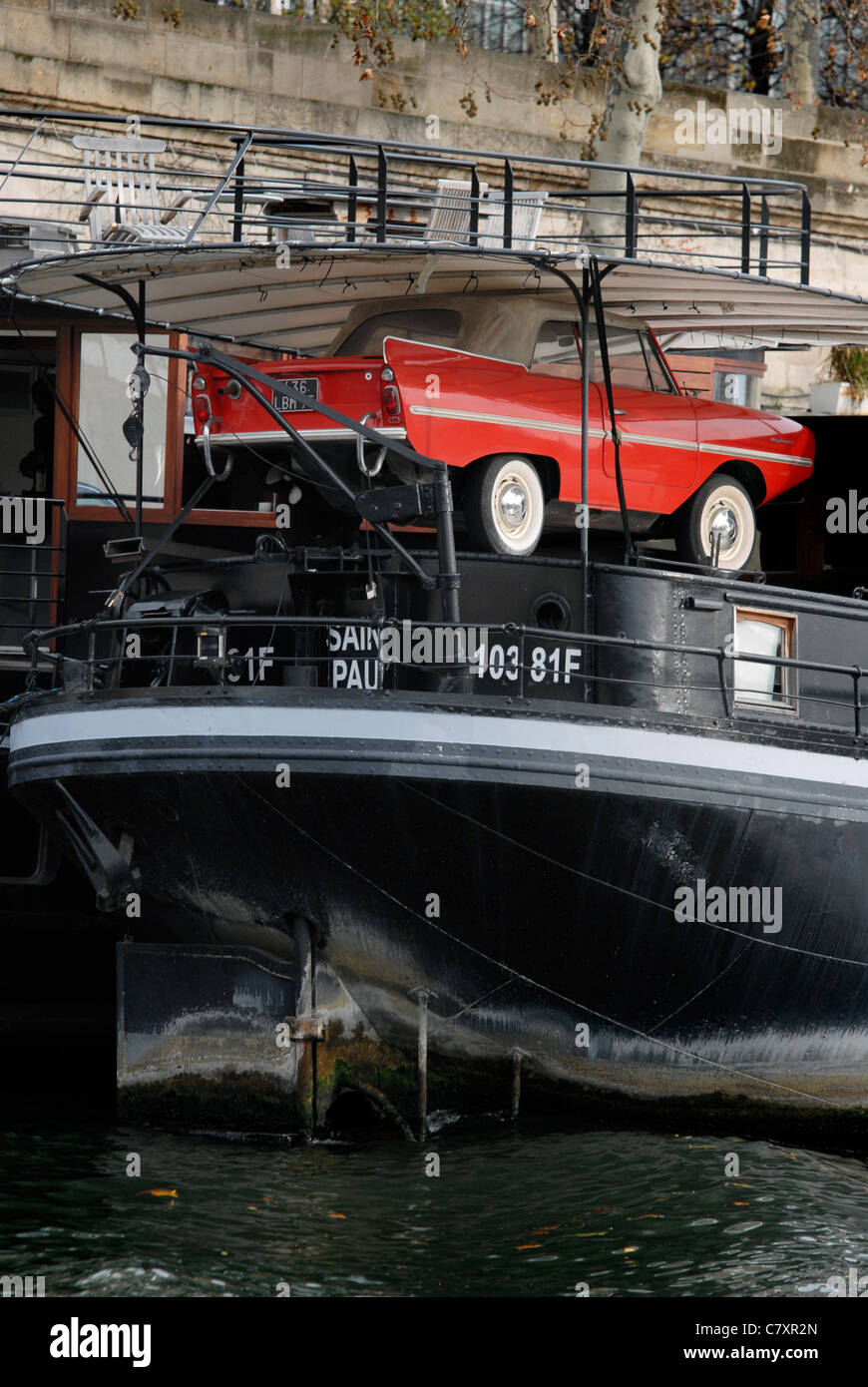 An Amphicar amphibious car on the back of a houseboat on the River Seine, Paris. Stock Photo