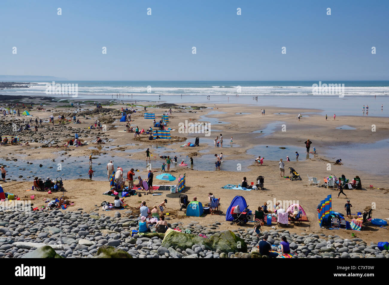 People Enjoying A Sunny Summers Day On Westward Ho Beach On The North 