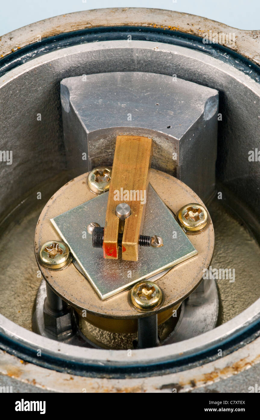 Low torque potentiometer with a weighted pendulum in a sealed housing for outdoor use as an angle sensor on a crane jib. Stock Photo