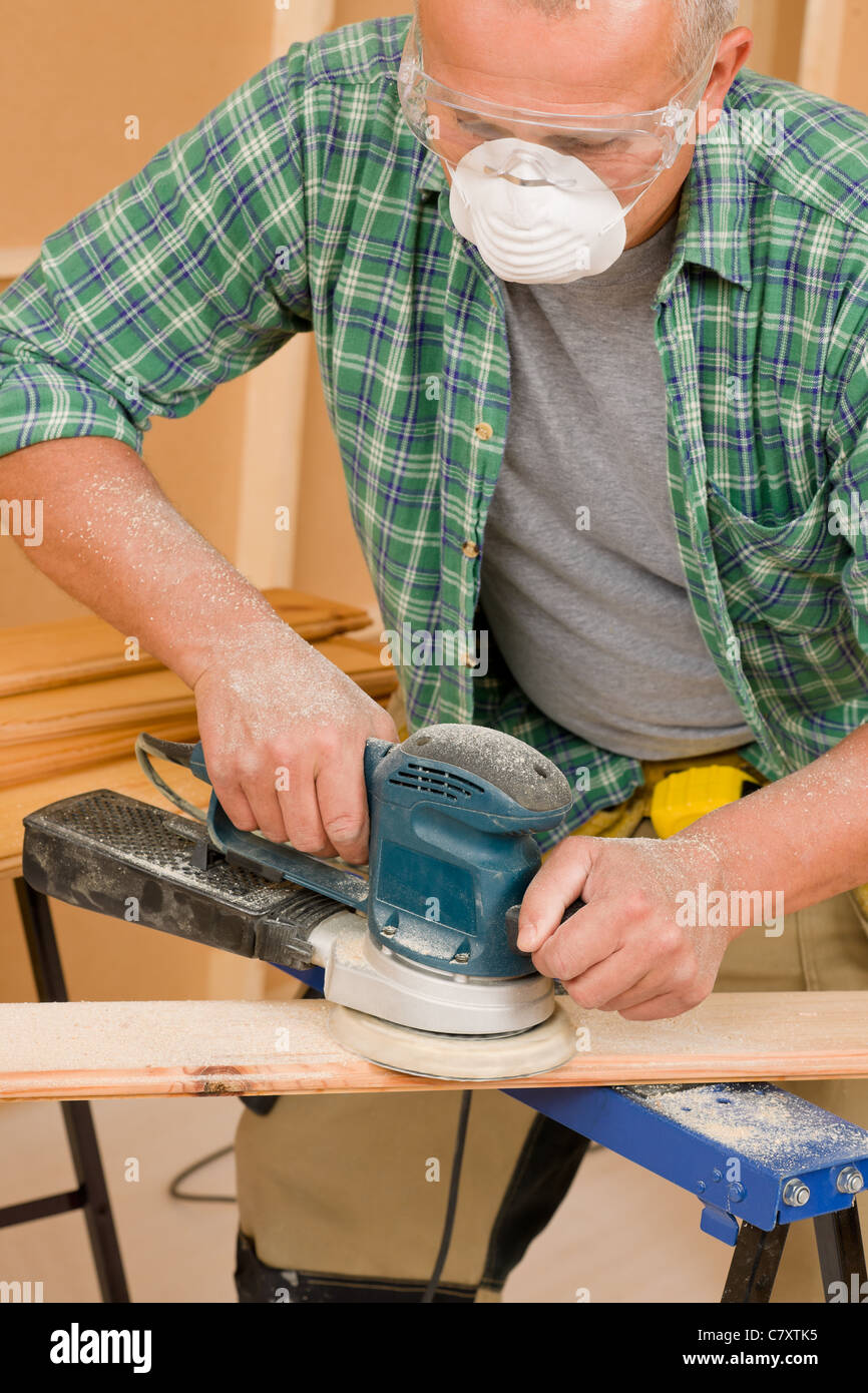 Handyman mature professional sanding wooden board diy new home renovation Stock Photo
