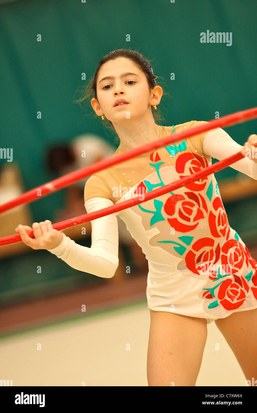 Young girl performing exercise with gymnastic circle @ Ferrara B Series Italian Rhythmic Gymnastic Tournament Stock Photo