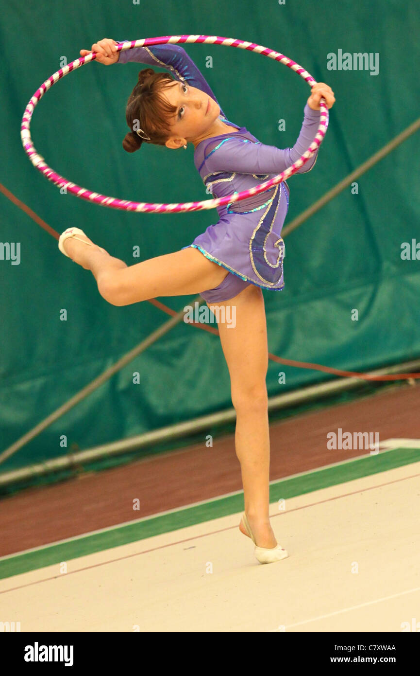 Young girl performing exercise with gymnastic circle Ferrara B Series